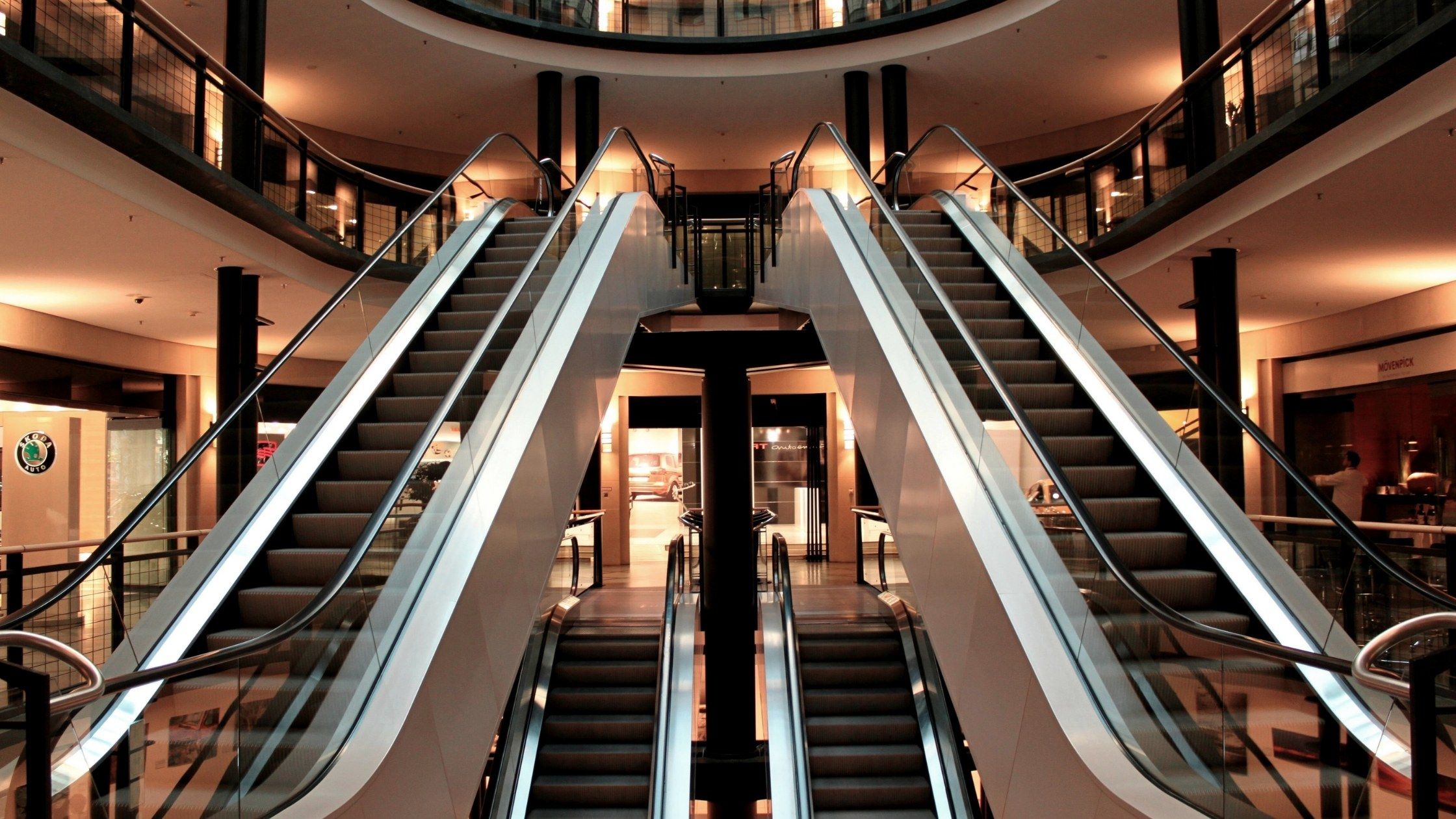 two escalators inside a mall