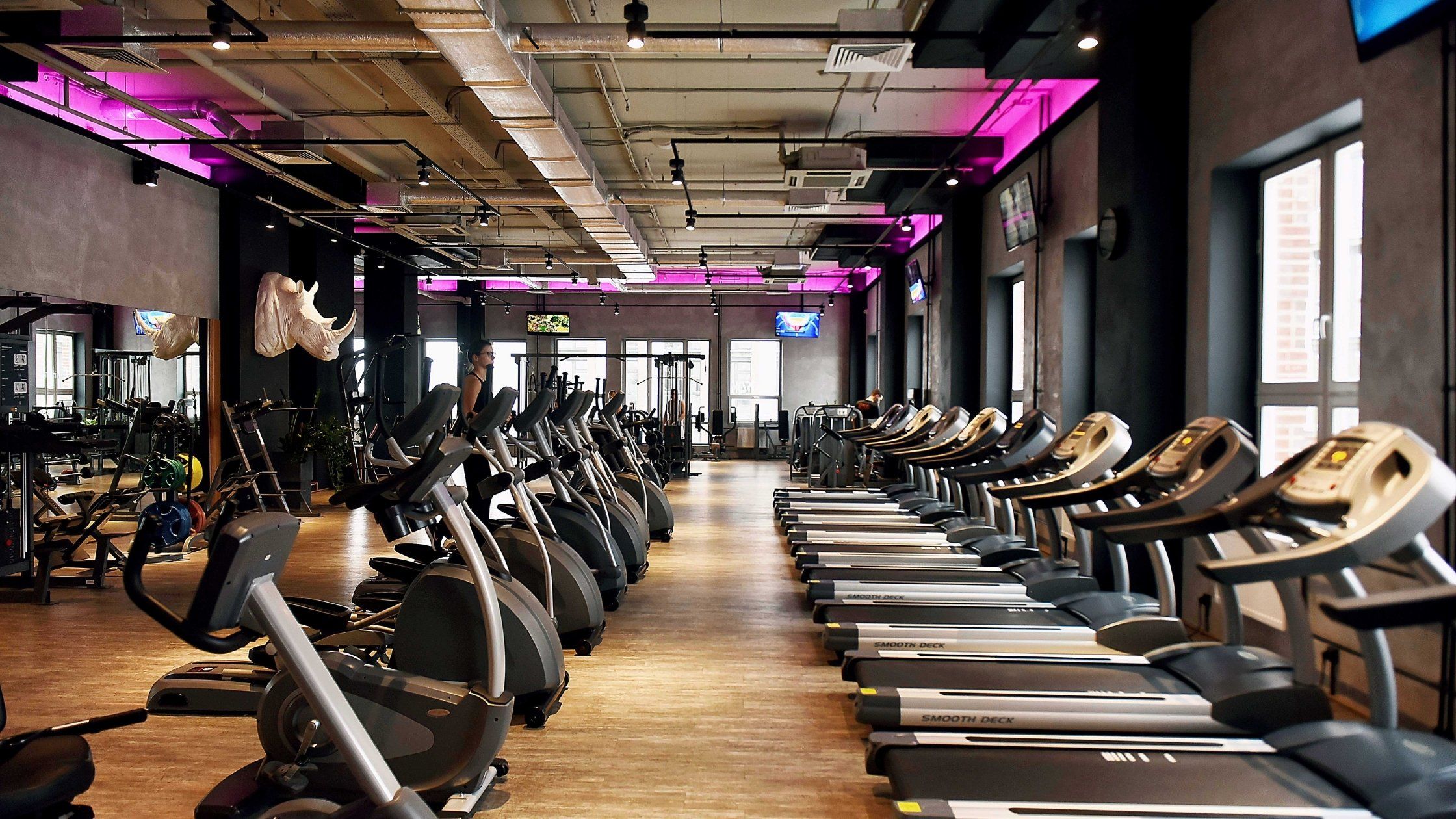 inside view of a gym featuring treadmills