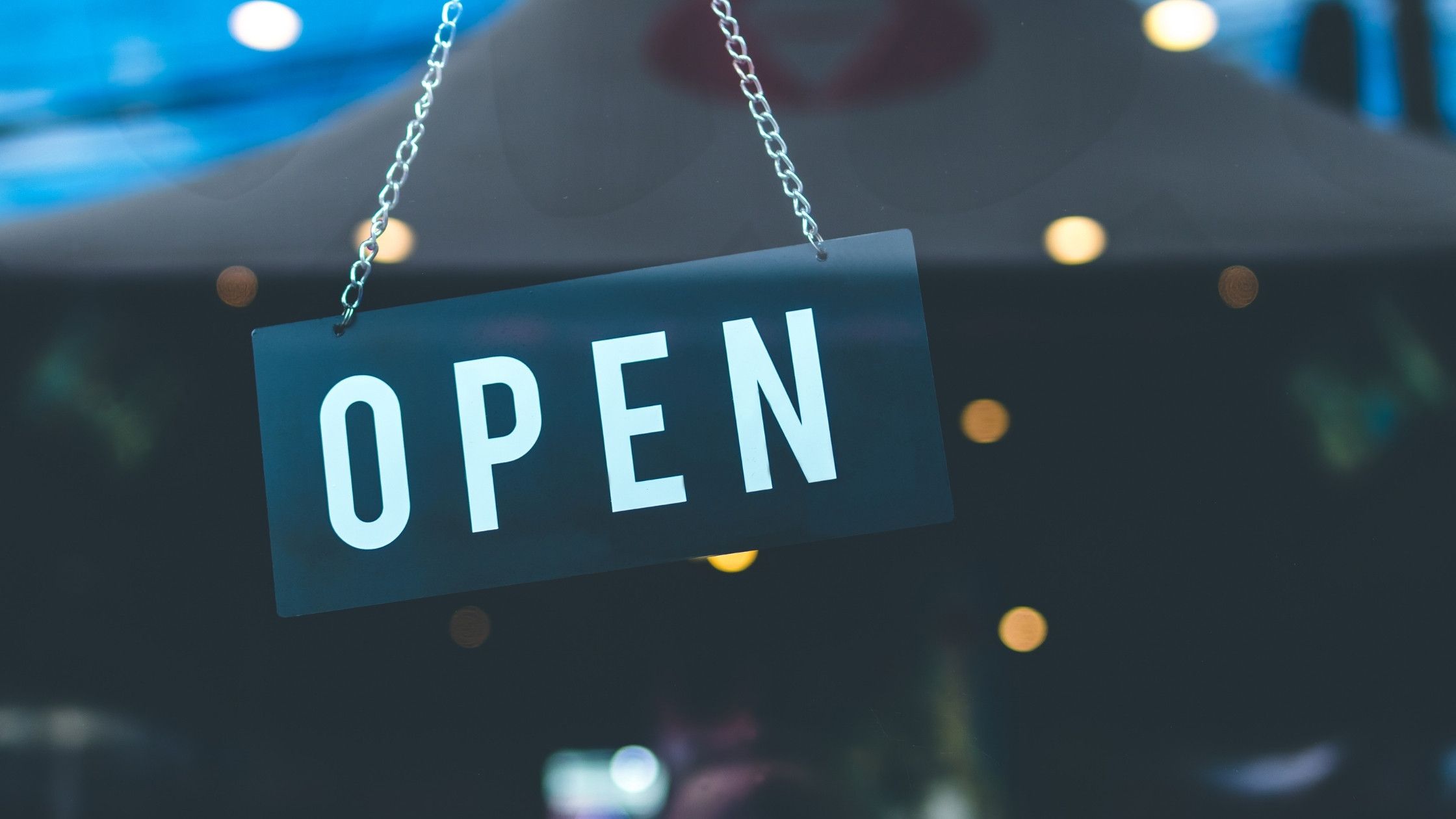 open sign hanging in a commercial store window