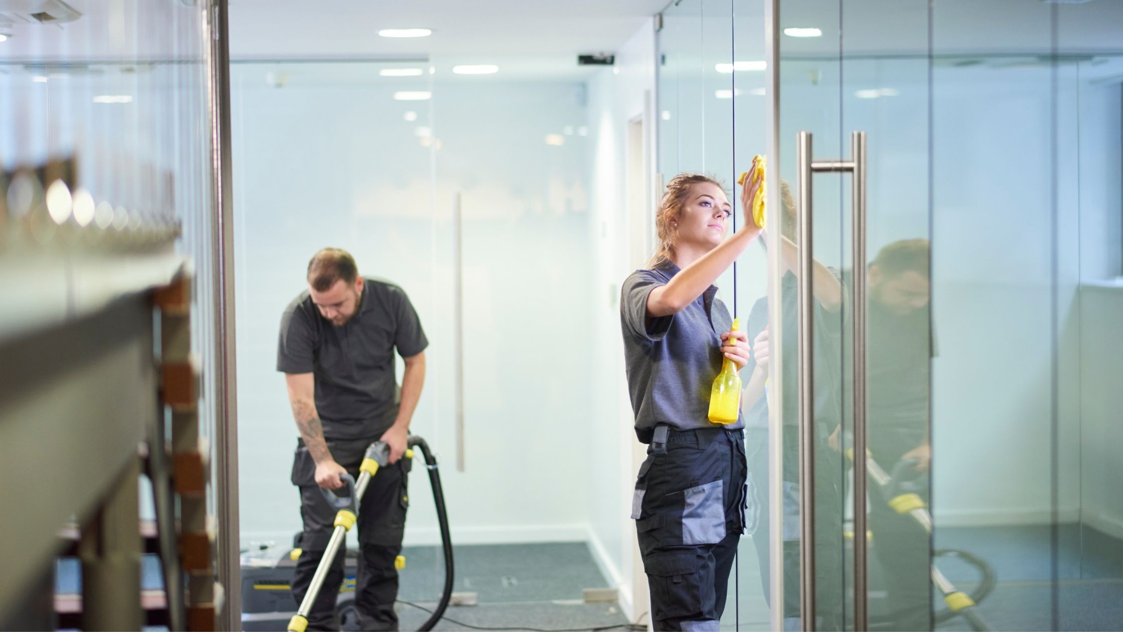 two professional cleaners cleaning an office building